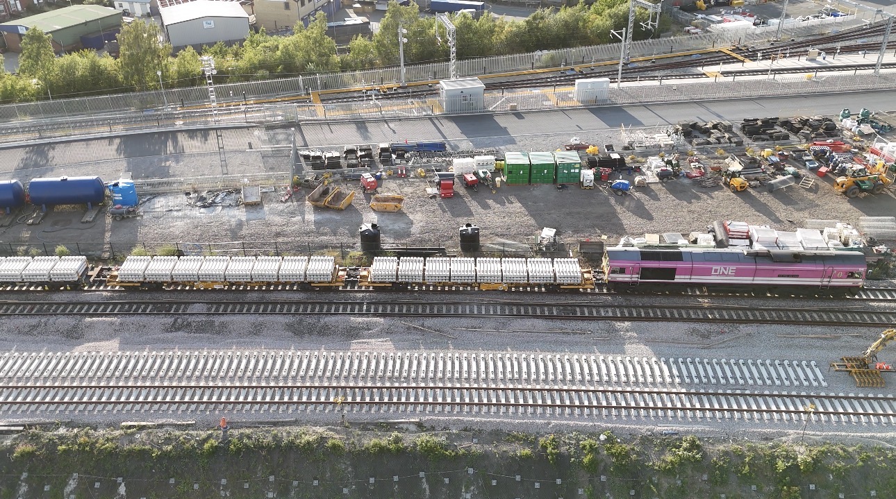 Freightliner Class 66 locomotive delivering engineering materials including concrete sleepers to the TRU worksite