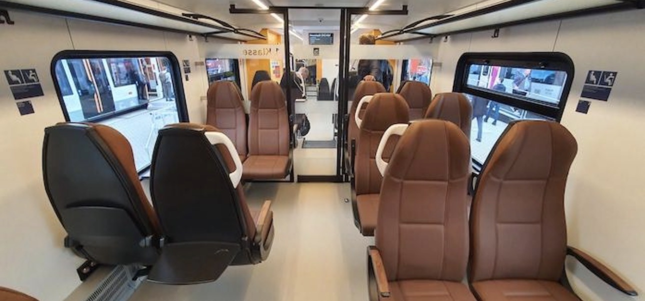 Interior of the Stadler FLIRT Akku — leather seating, wide gangways and a modern finish across both classes